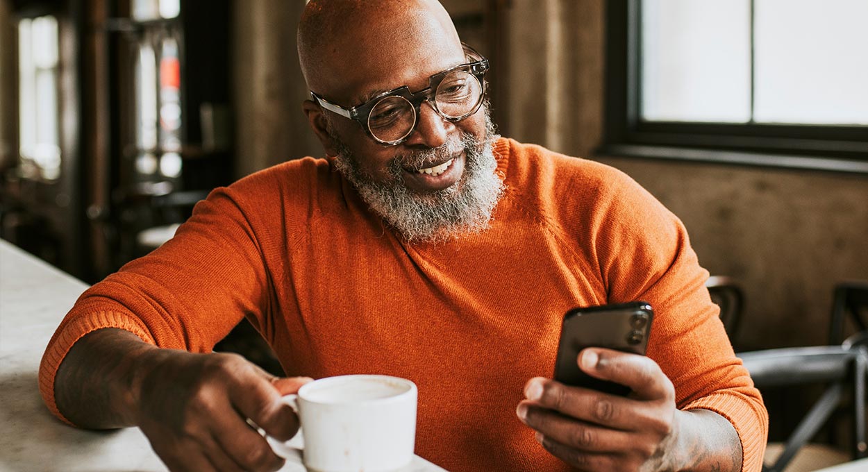 Bearded man checking his phone