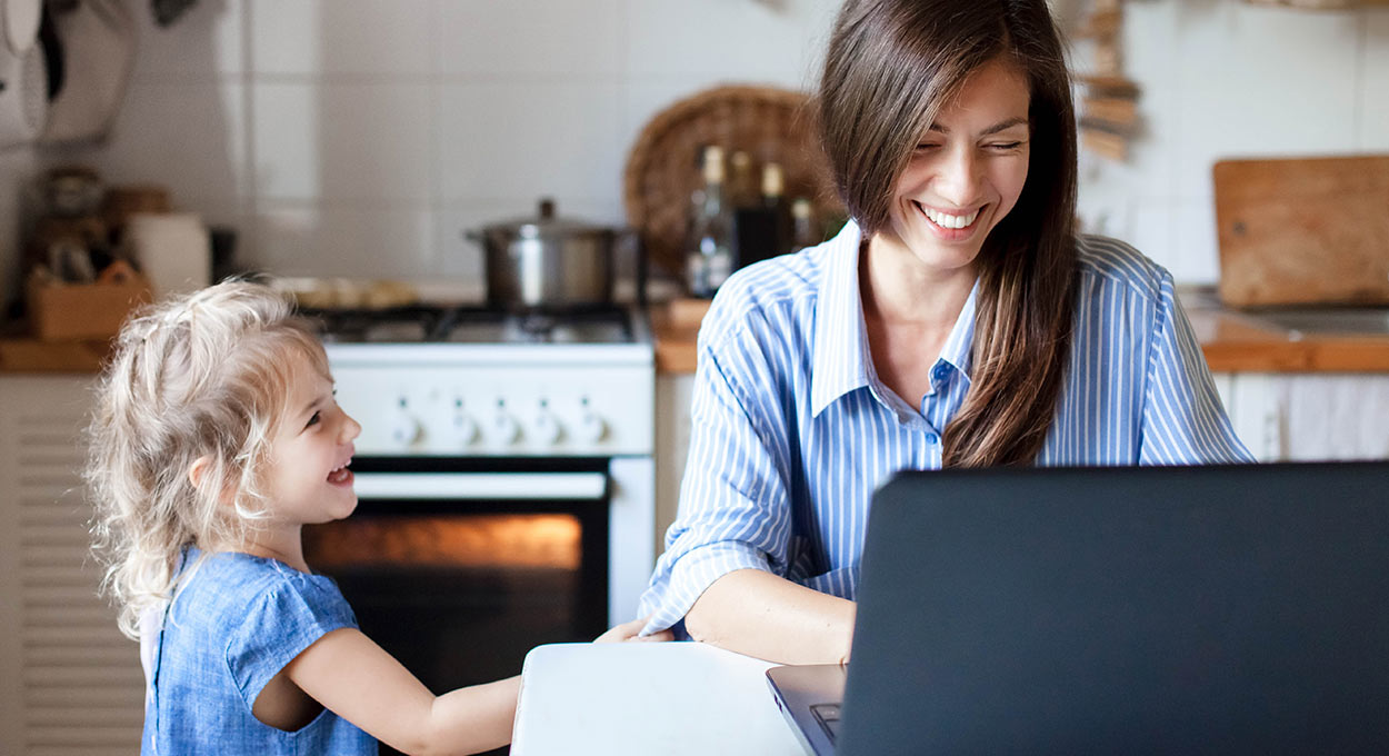 Mom works from home office with her daughter by her side