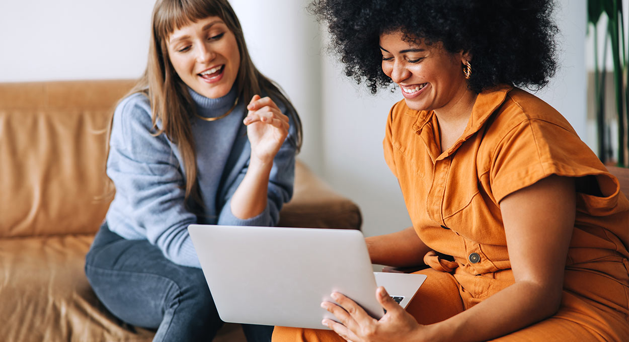 Young businesswomen using a laptop together in an office
